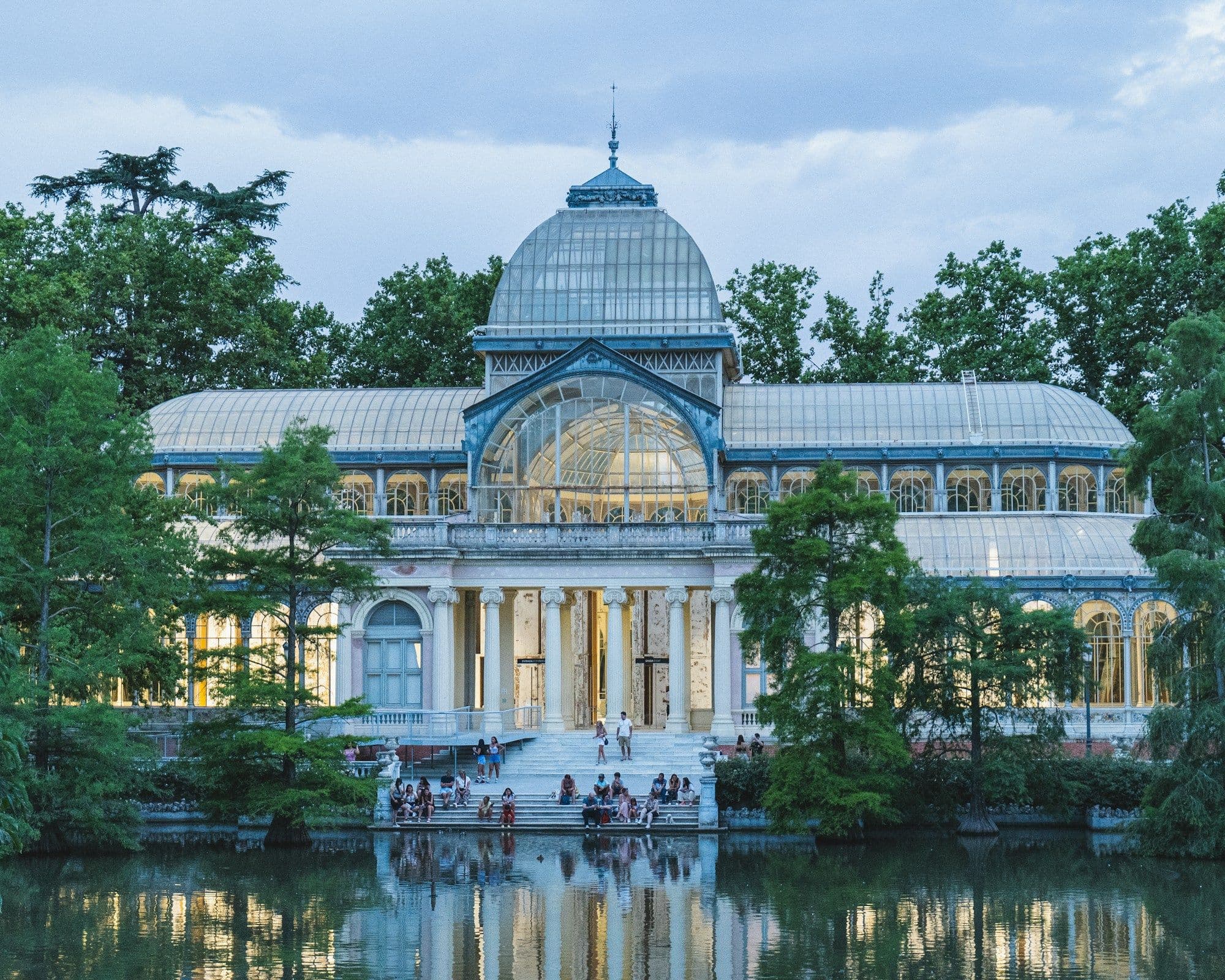 A domed building reflected in water at Retiro Park in Madrid.