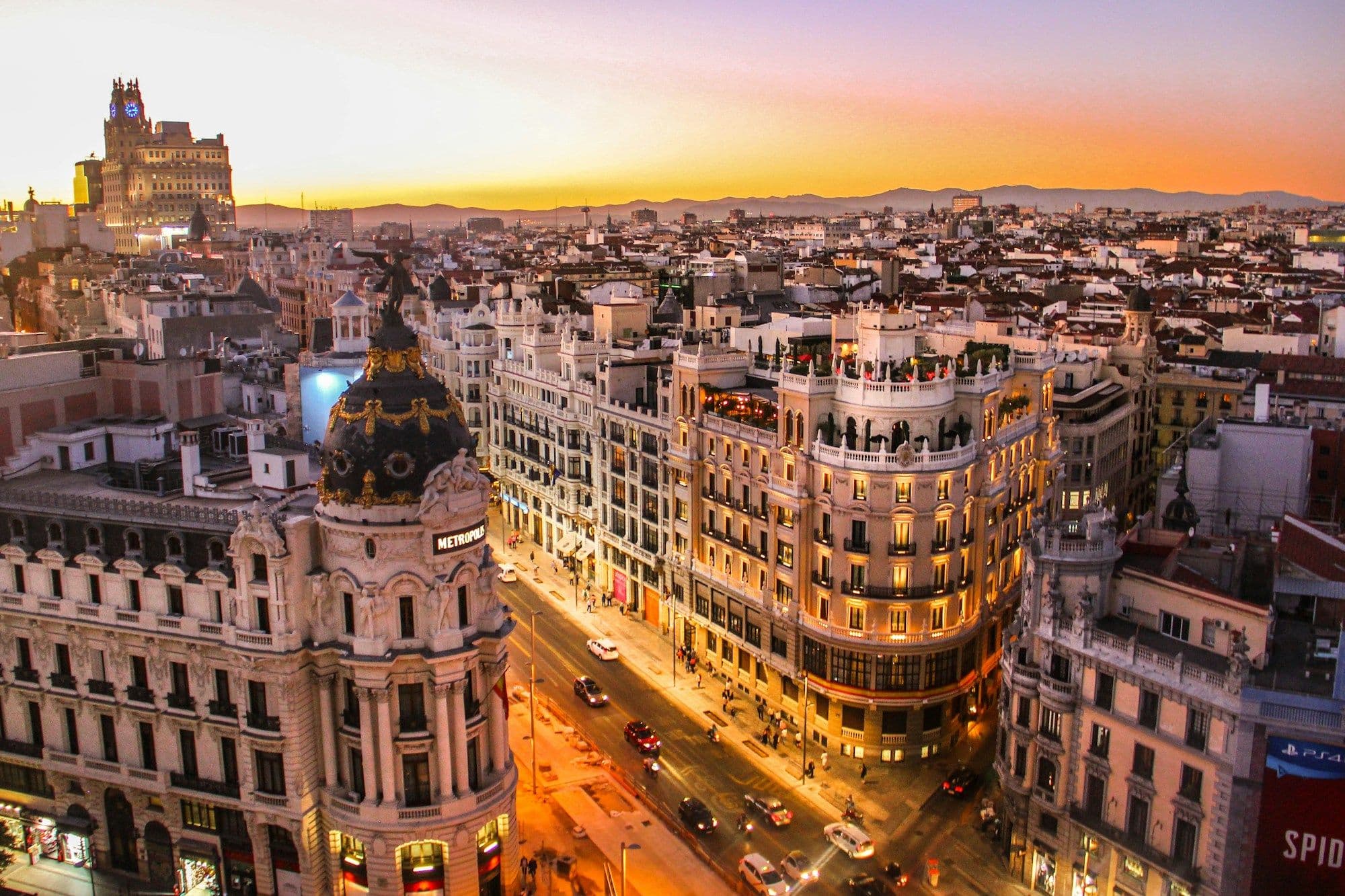 The Metropolis building and Gran Vía seen from above in late sunlight.