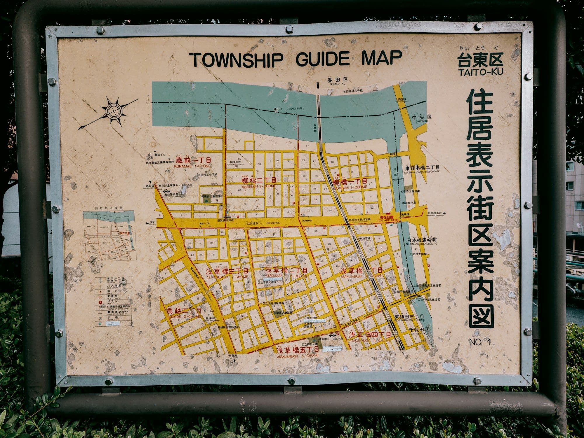 A paper town map showing roads, a river and marked locations.