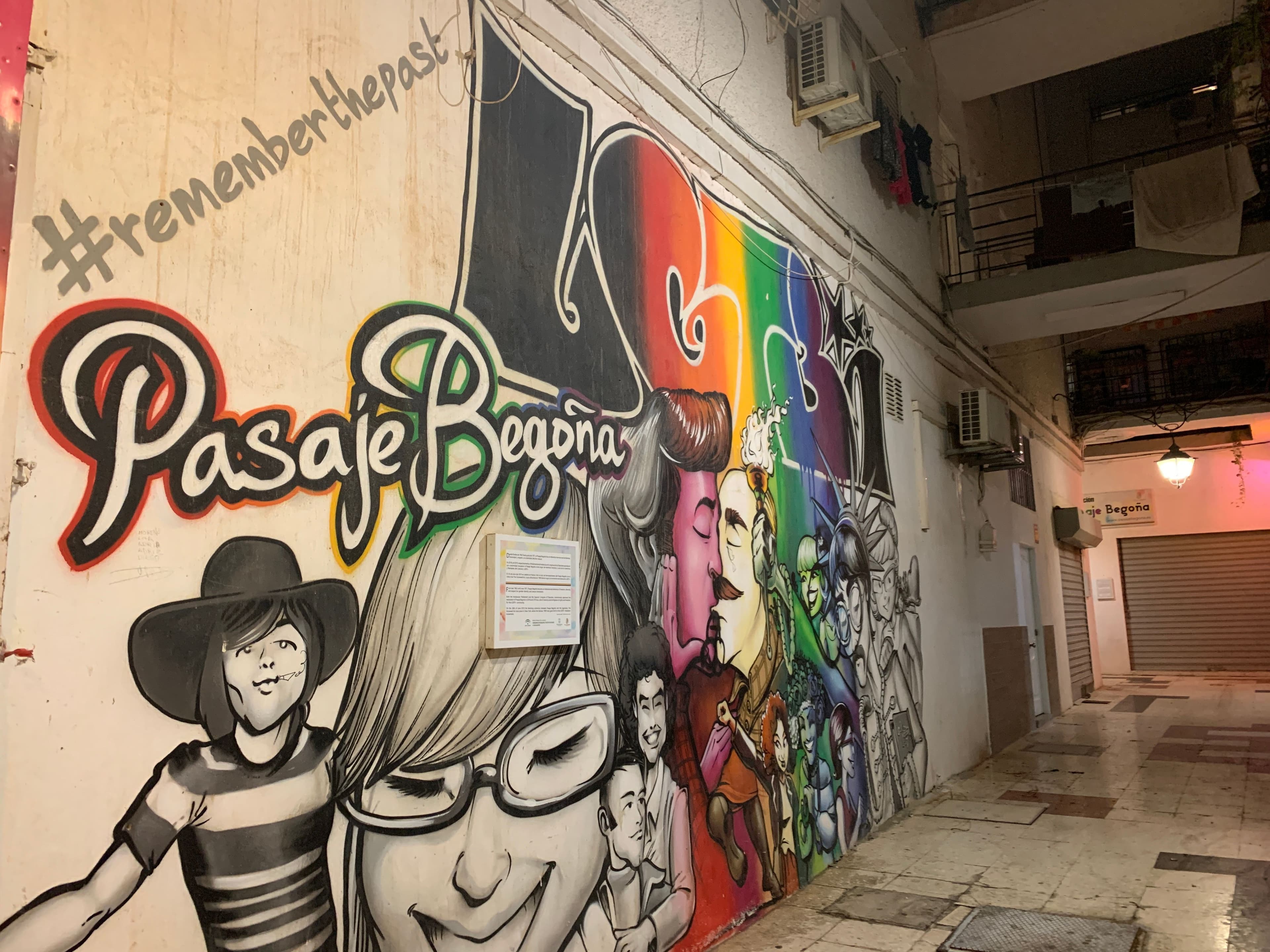 A colourful mural in the Pasaje Begoña in Torremolinos, with the name painted in large letters, rainbow stripes and the hashtag remember the past.