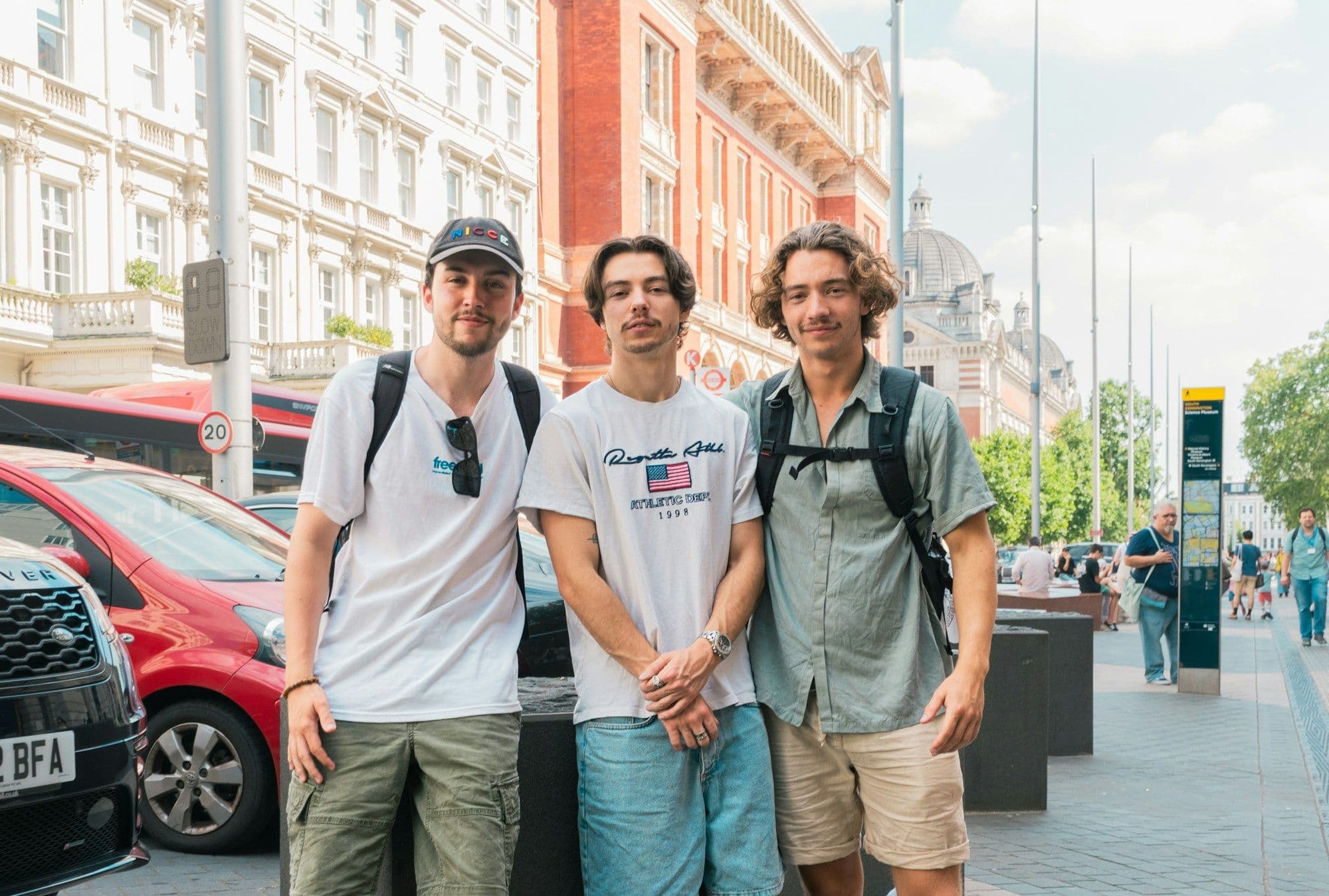 A group of friends standing together on a city sidewalk.