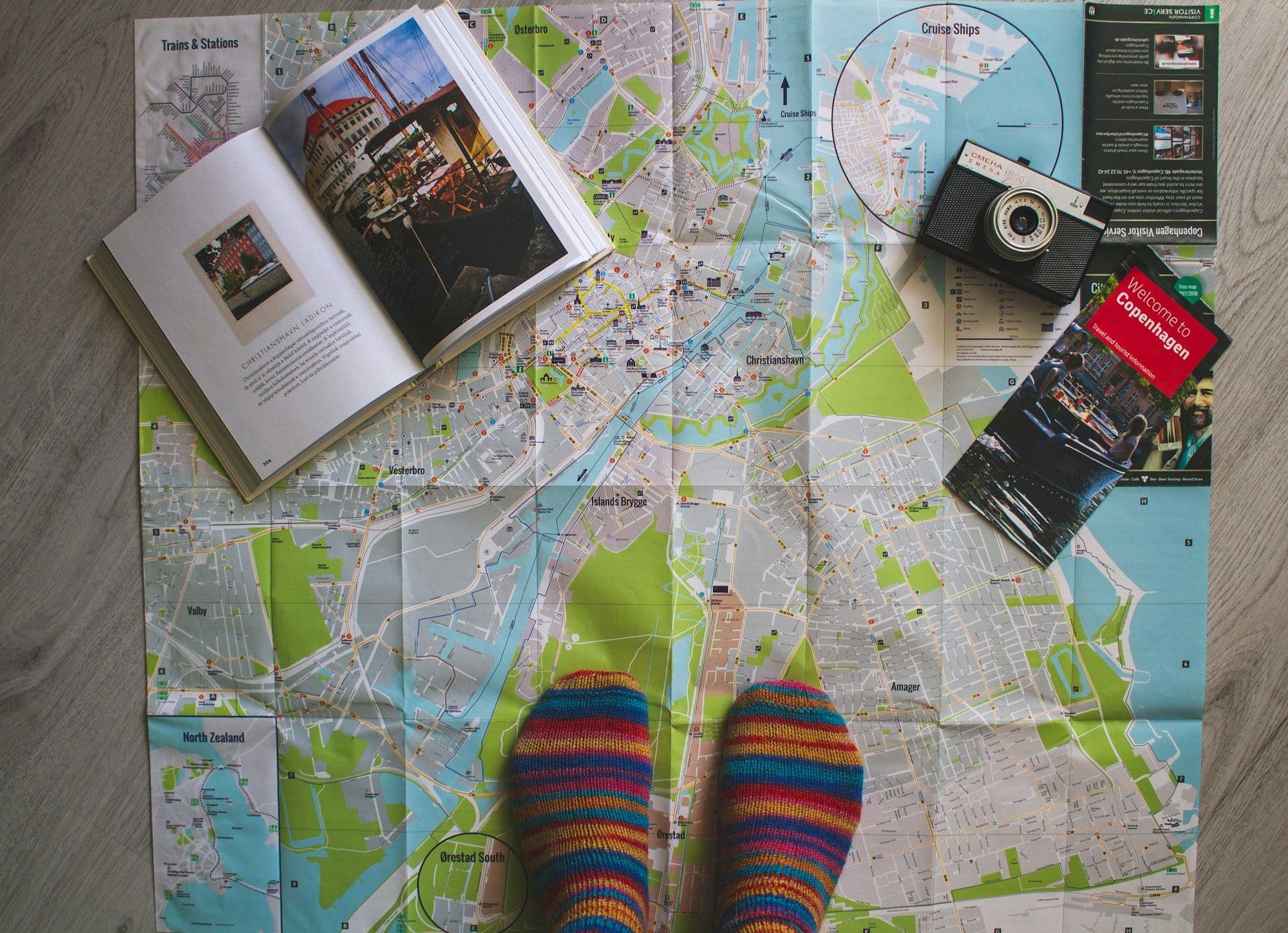 A traveler's shoes standing over a paper street map.