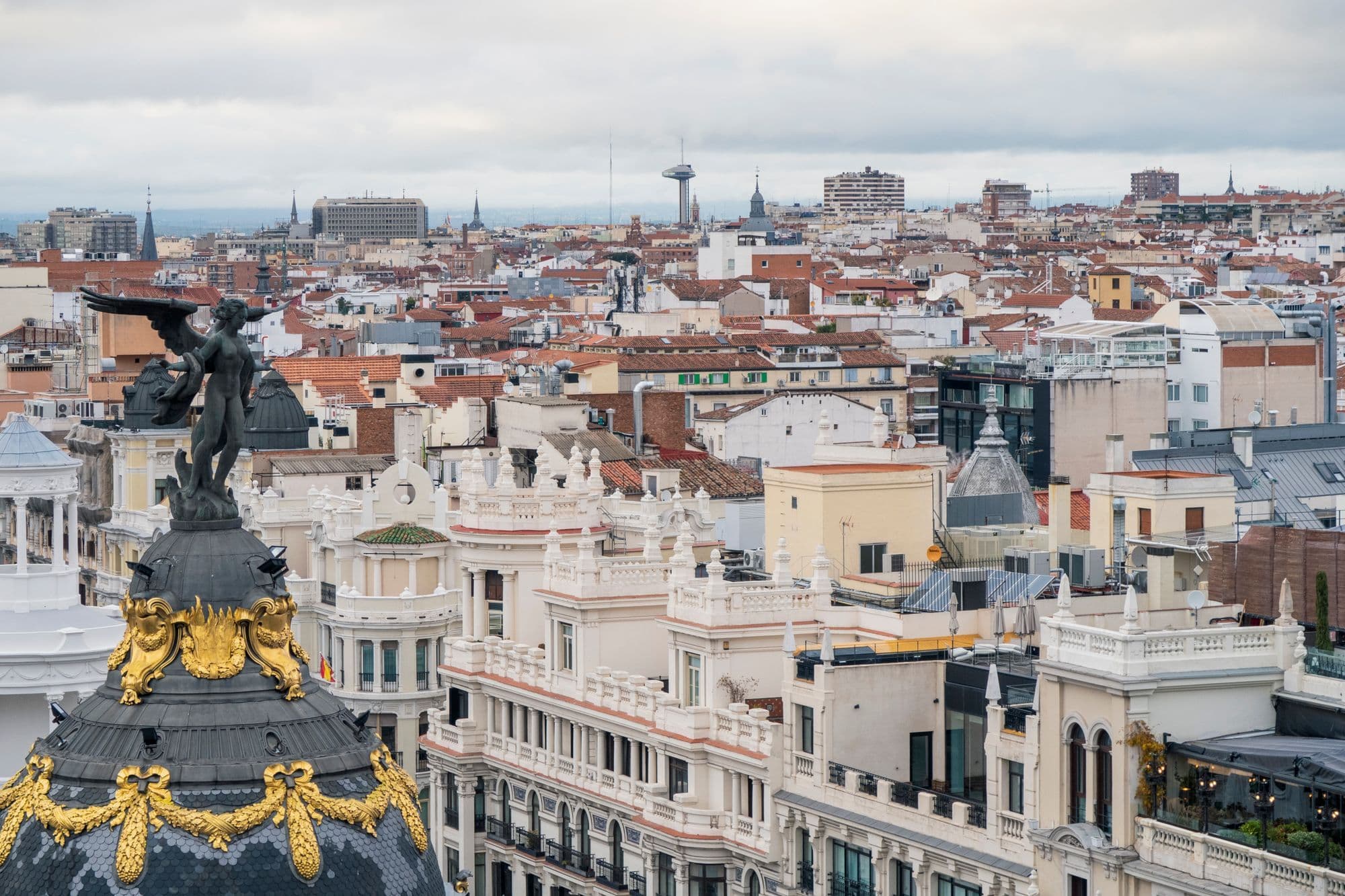 Madrid's Metropolis Building rises above the rooftops beside Gran Vía.