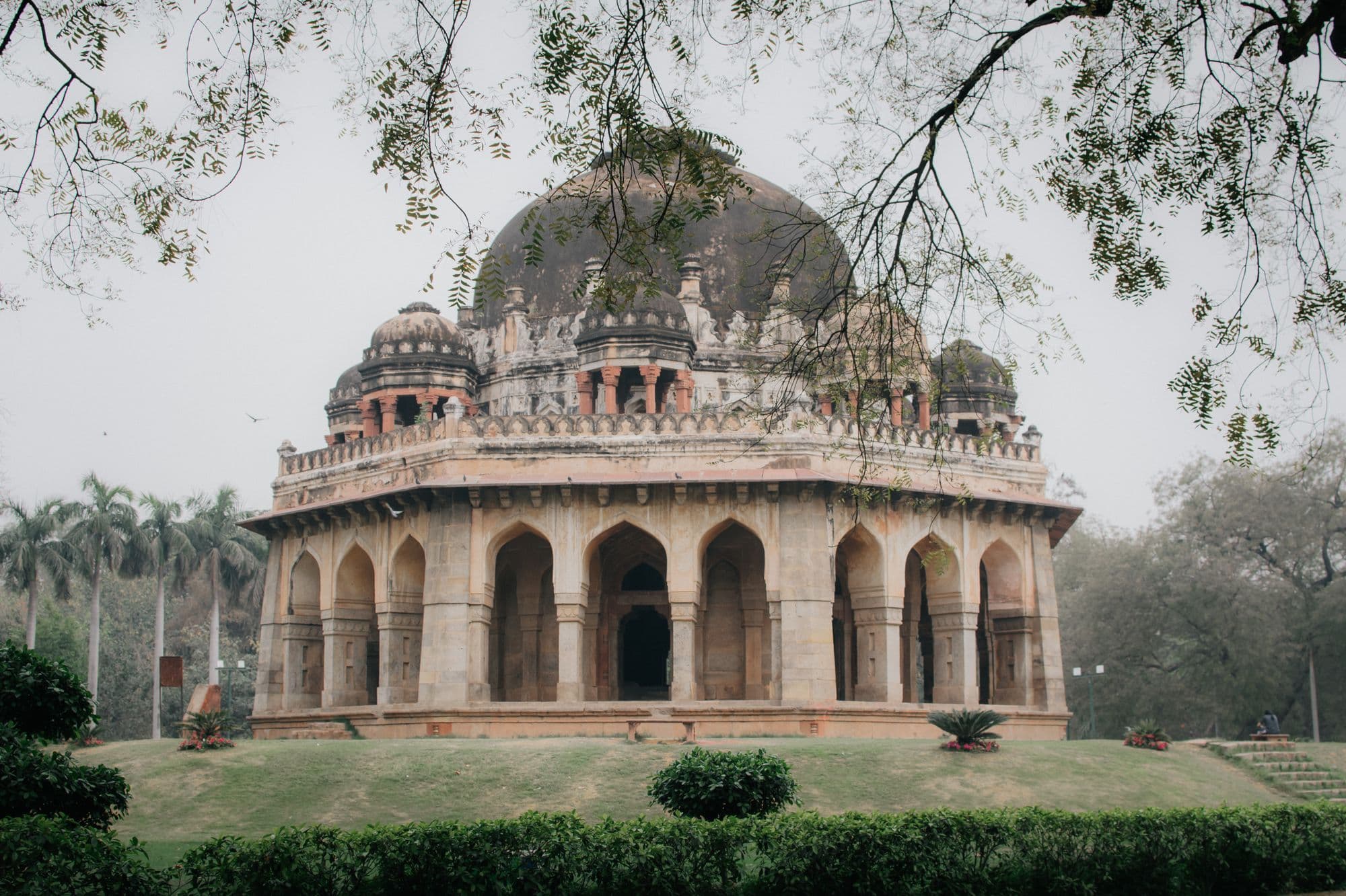 The domed octagonal tomb of Sikandar Lodi surrounded by trees and lawns in the Lodhi Garden, New Delhi.