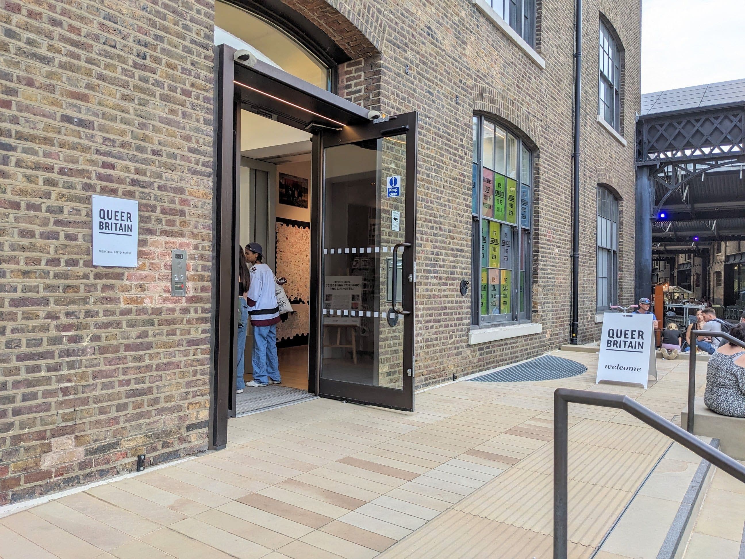 The glass entrance of the Queer Britain museum on Granary Square in King's Cross, London.